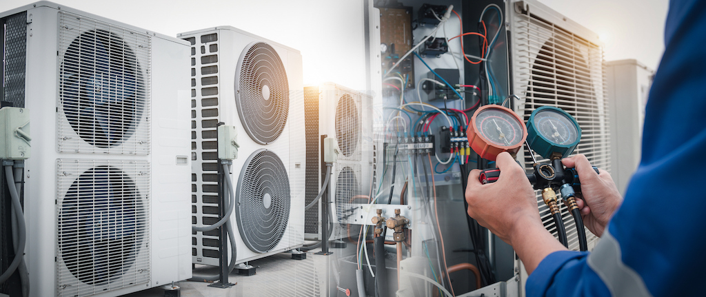Technician working on commercial AC units. | Commercial AC Installation