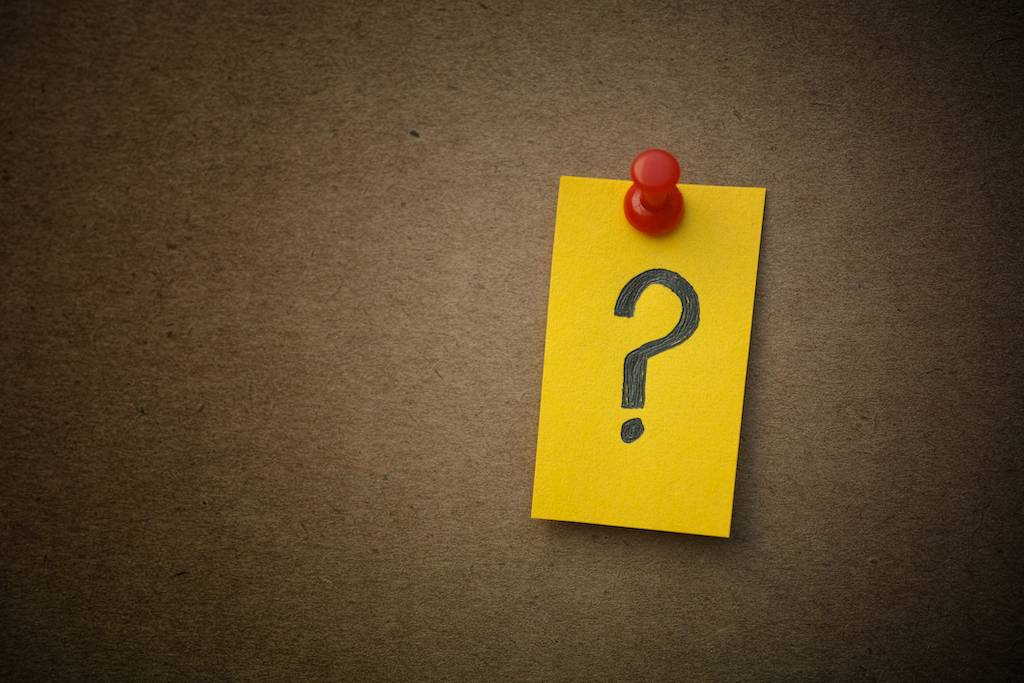 Question mark on sticky note with red push pin. | 
