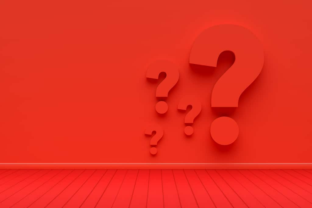Four red question marks on red background. 