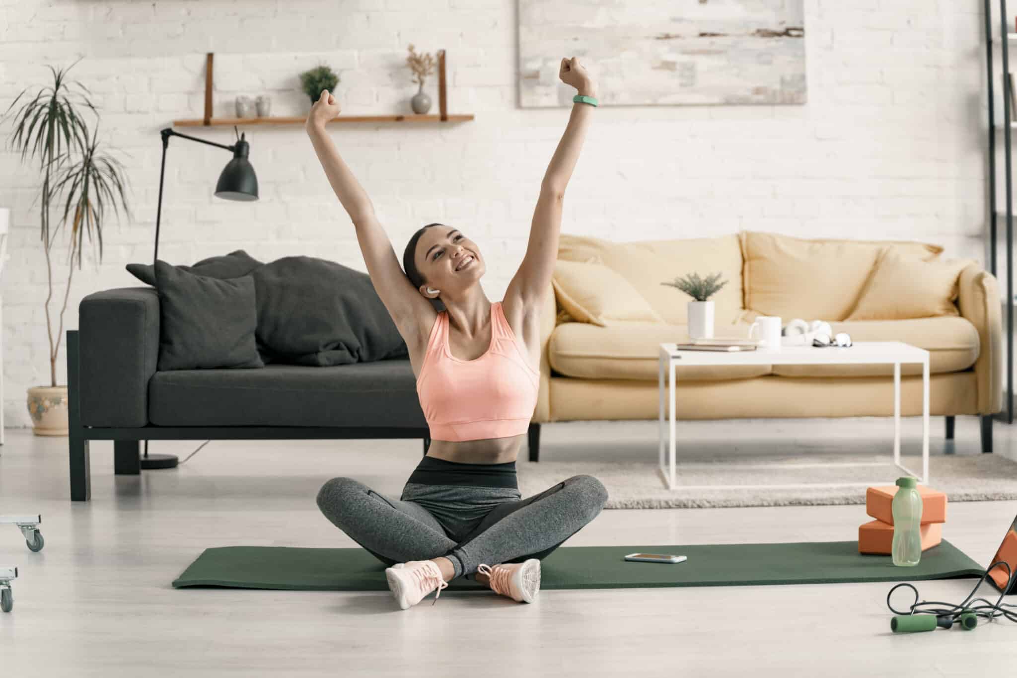 Happy fit female stretching in sitting-room stock photo maintaining a healthier indoor environment, HVAC Settings.