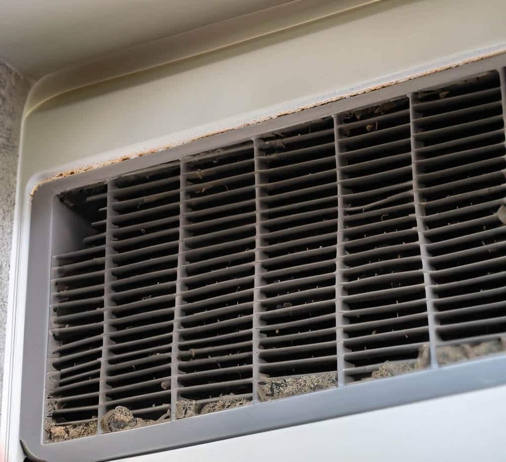 Dirty Air filter that signals you need to schedule a duct cleaning service.