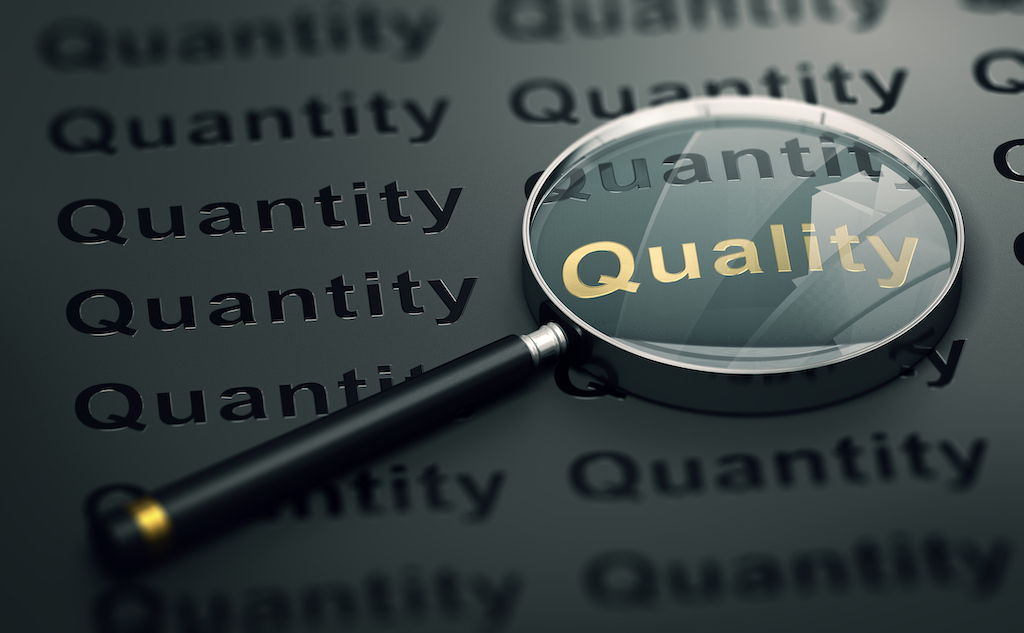 Magnifying glass on the word 'quality' representing quality over quantity when it comes to heating and AC repair.