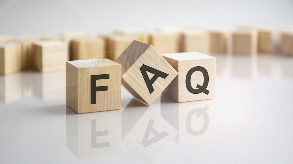 wooden blocks spelling out FAQ representing common questions about air conditioning service. 