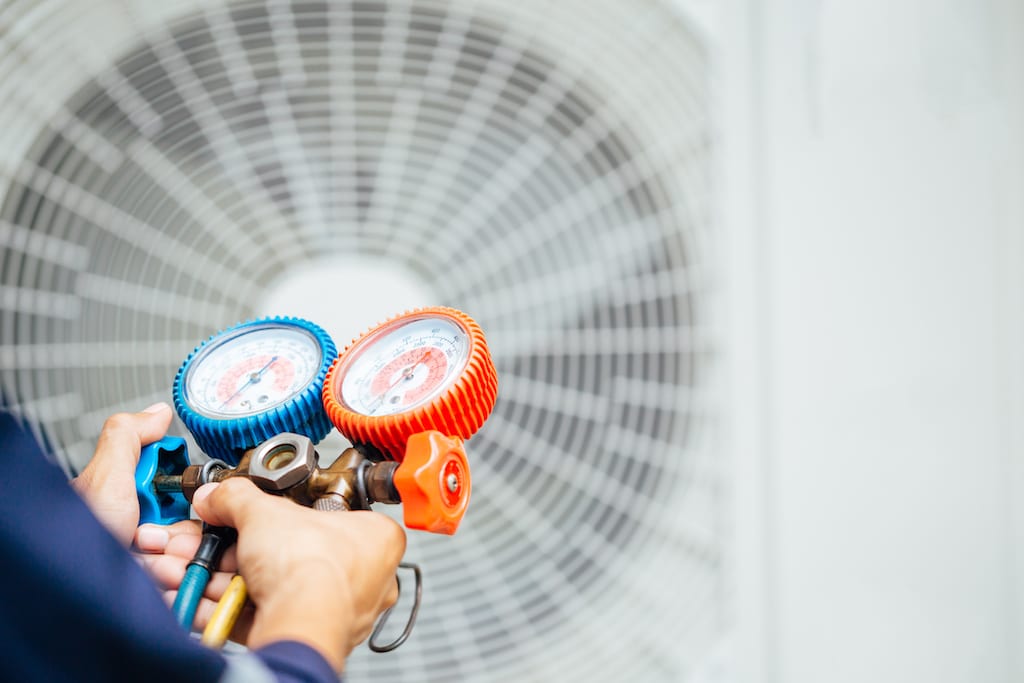 Technician doing AC repair.