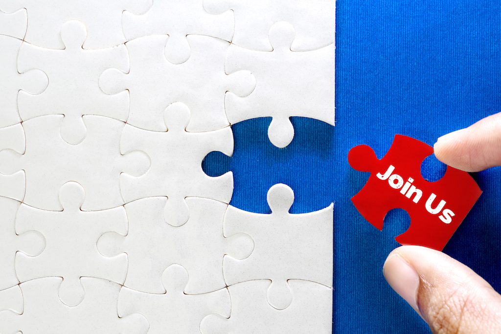'Join Us' red puzzle piece going onto white puzzle and blue background. AC repair.