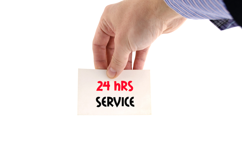 Mans handing holding sign reading '24 hrs service' | Air Conditioning Service