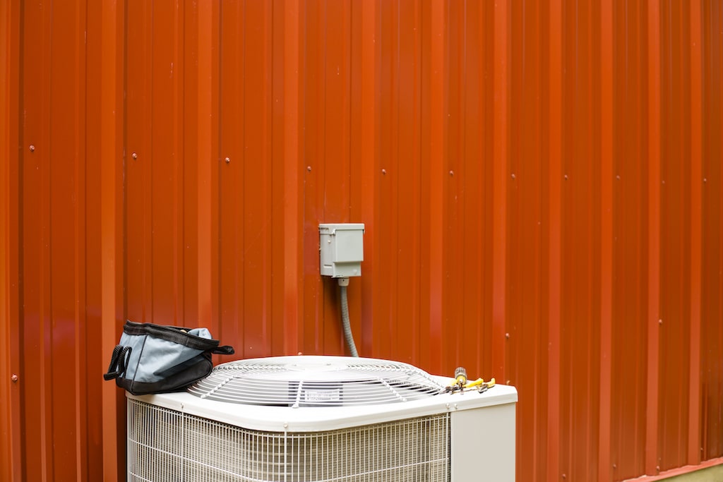 Air Conditioner with red background. | AC Repair in Watauga
