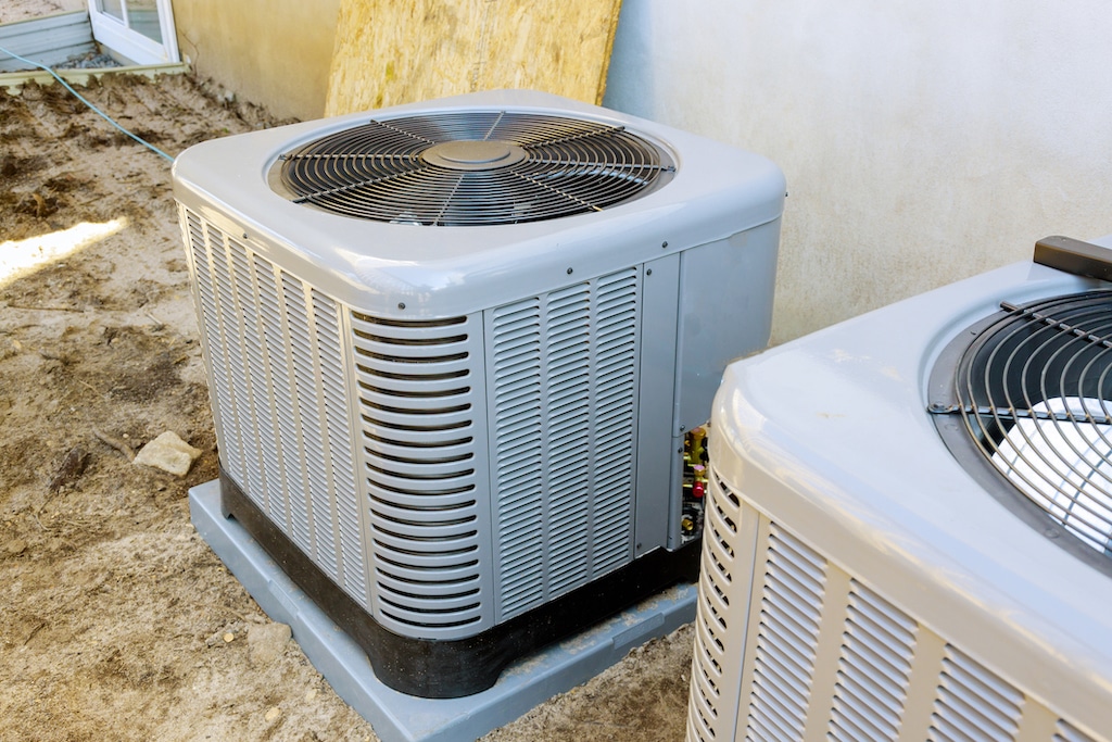 AC unit outside in new build of home, construction dust. | Compound Gauge HVAC