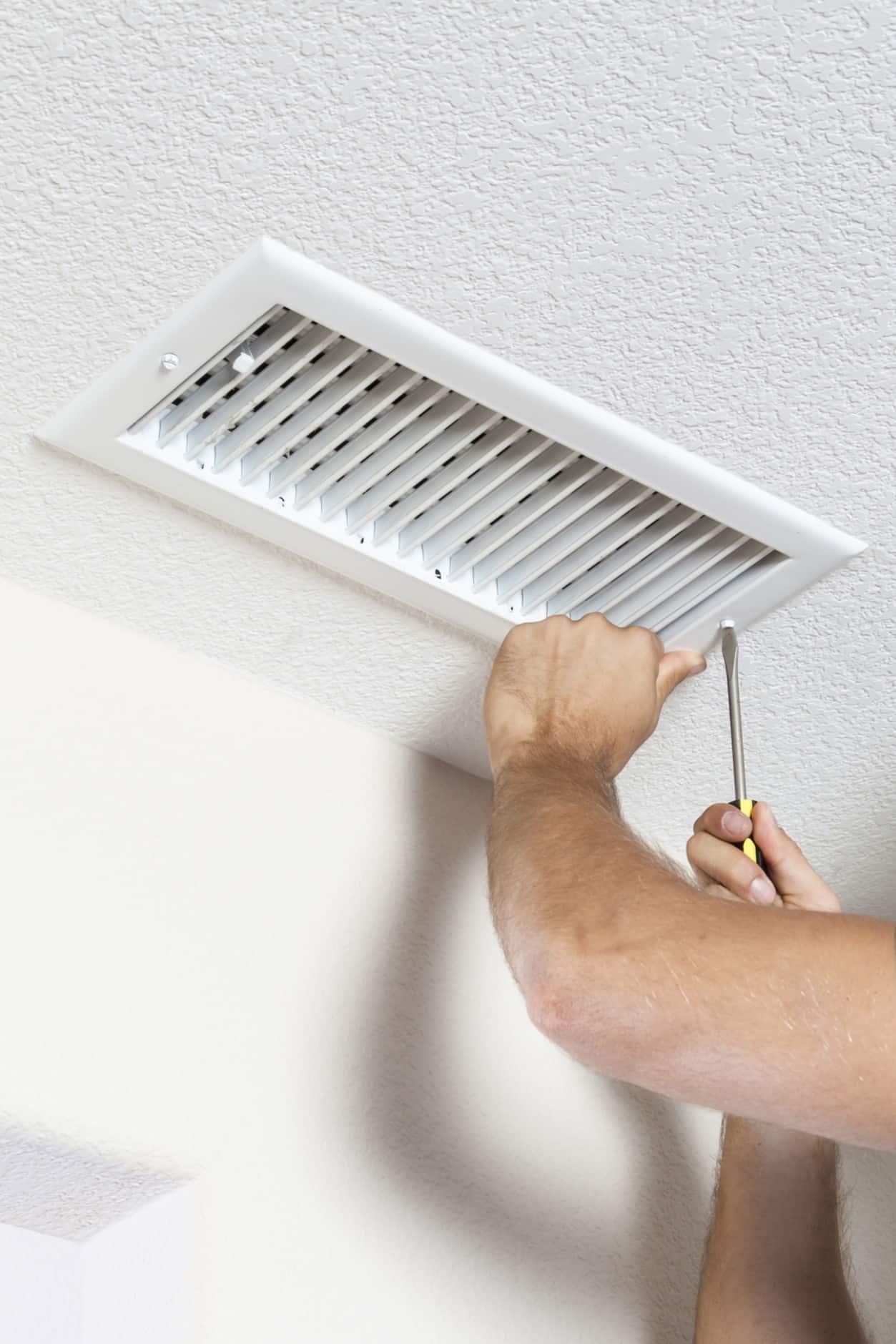 Man cleaning air ducts in home, Temperature Zoning.