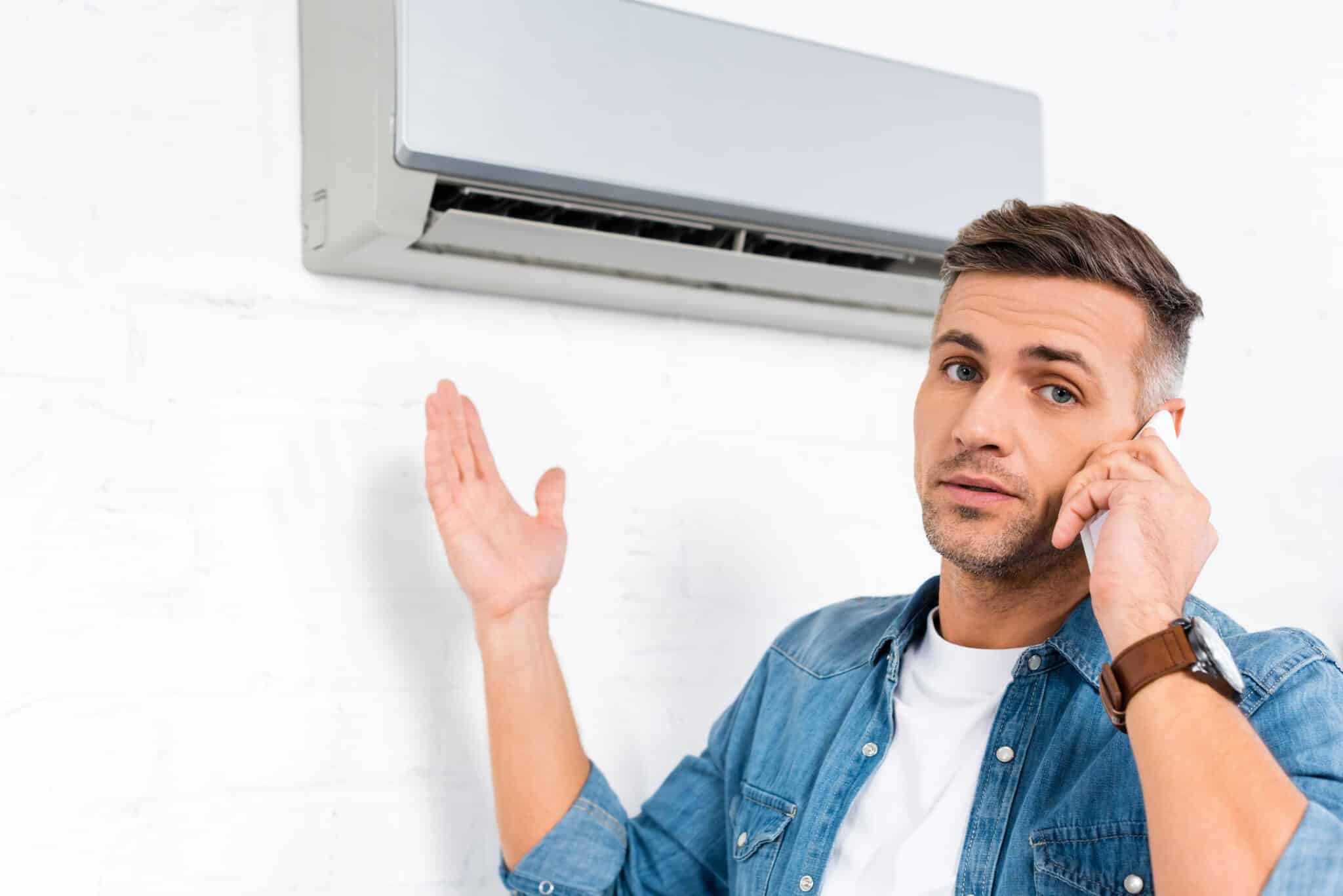 A man calls HVAC professionals because his air conditioner is blowing hot air.
