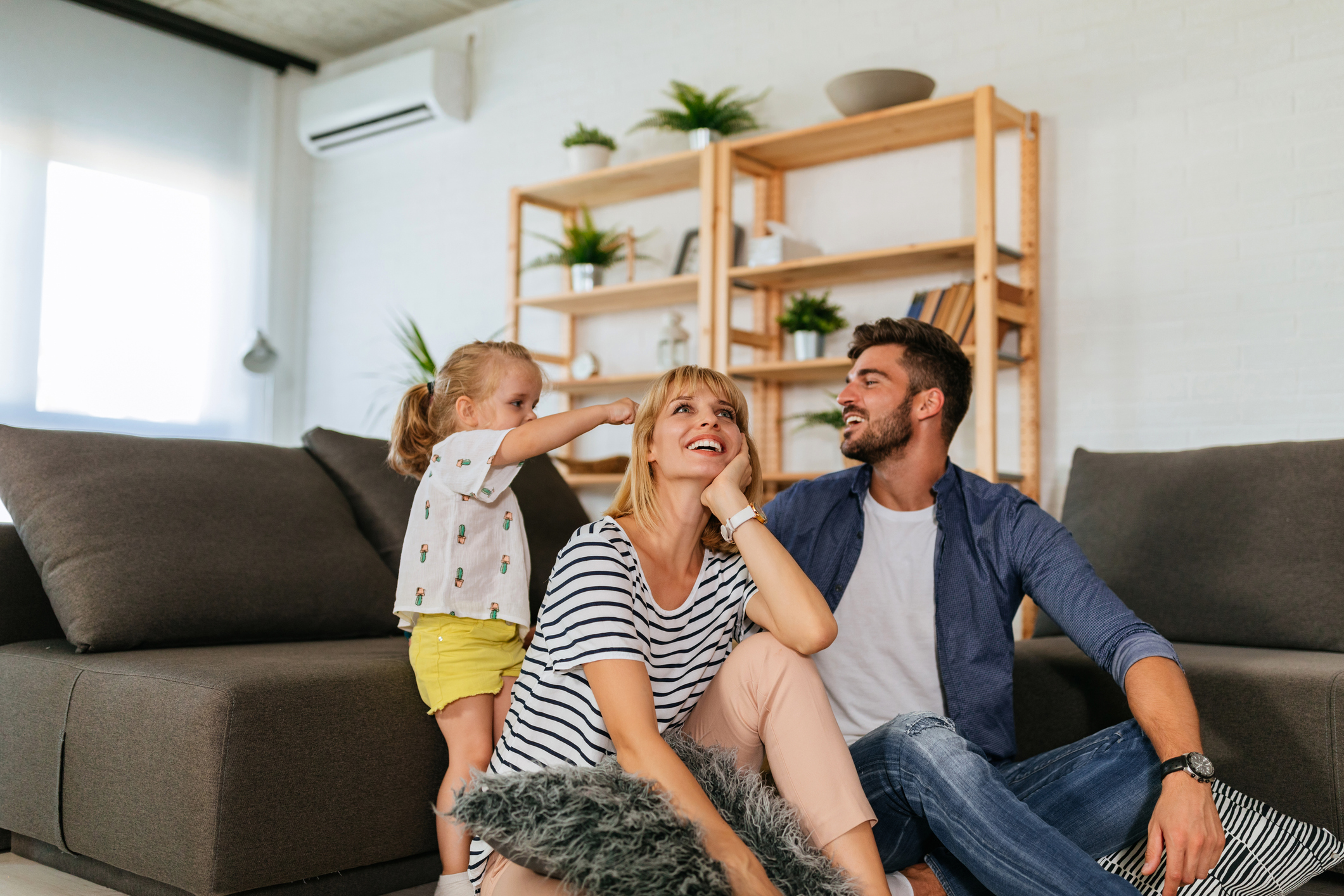 Cheerful family of three playing together at home, Benefits, Outdoor coil cleaning.