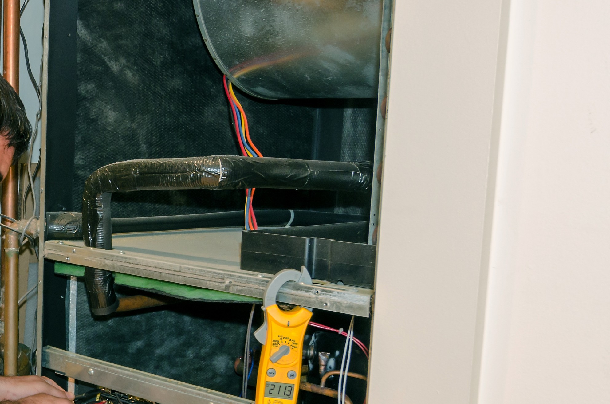 HVAC techs check voltage, Air handler leveling.